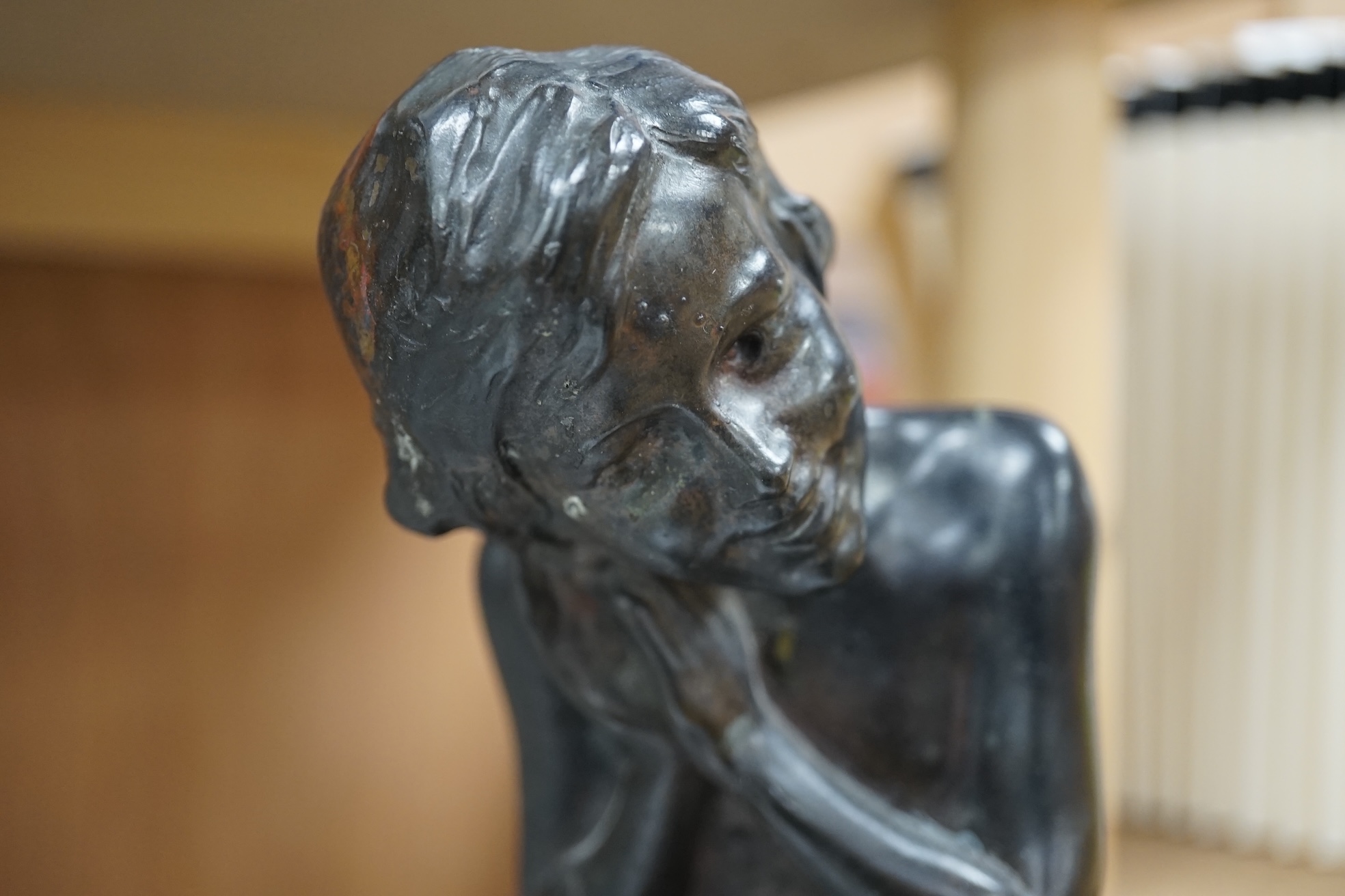 After Henri Pernot (1859-1937), a bronze figure of a boy seated on a bell, signed, 38cm high. Condition - fair to good